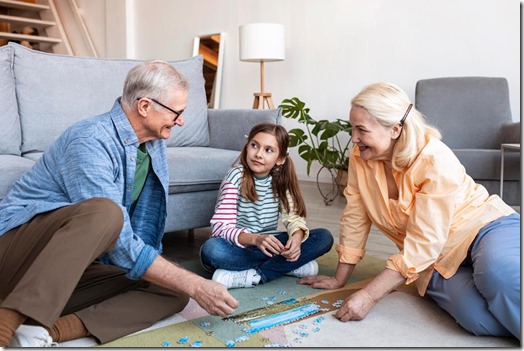 adults-and-girl-doing-puzzle-on-floor