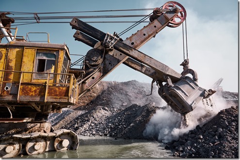 Quarry bucket excavator works in a slag dump