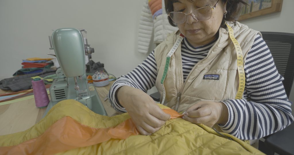Persona reparando una prenda de ropa en una tienda de Patagonia durante una jornada gratuita